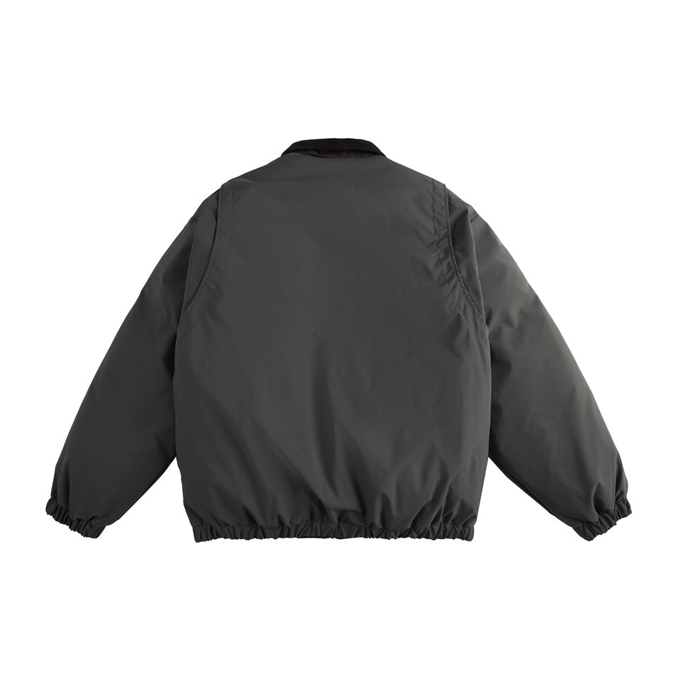 Back view of gray-green jacket with dark collar, shoulder seam panels and elastic hem and cuffs, flat view