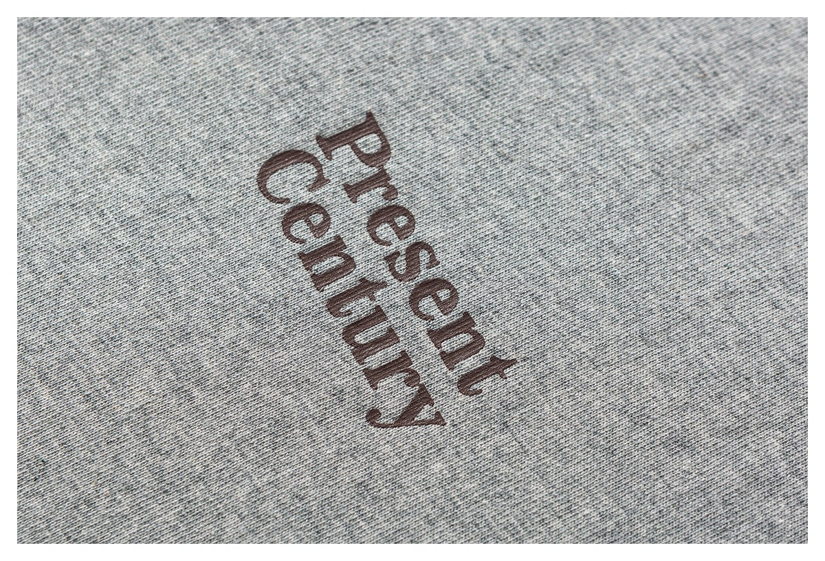 Close-up of heather-gray fabric printed with the words “Present Century.”