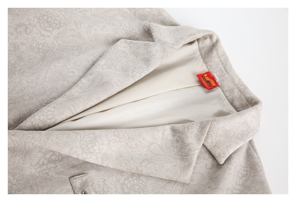 Pale beige floral-paisley blazer opened to show its cream lining and notched lapel.