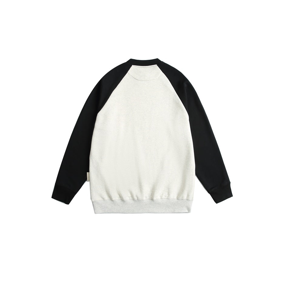 Back view of a cream raglan sweatshirt with black sleeves, shown flat against a white background.