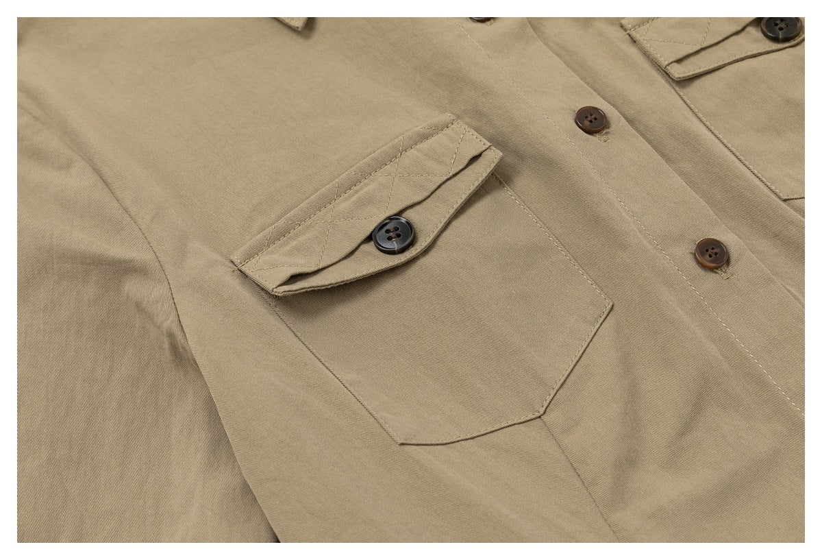 Close-up of a khaki shirt’s buttoned flap chest pocket and front buttons.
