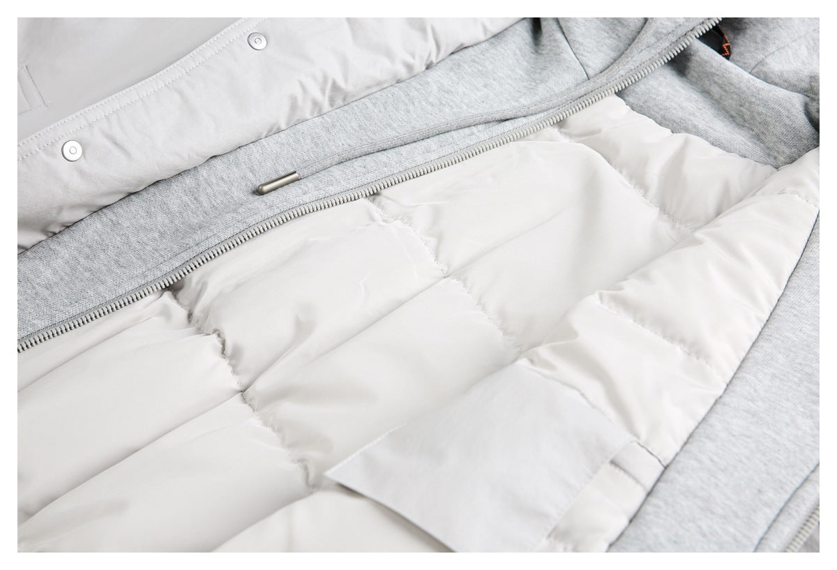 Close-up of a light gray and white padded jacket showing quilted lining, zipper, and snap fasteners.