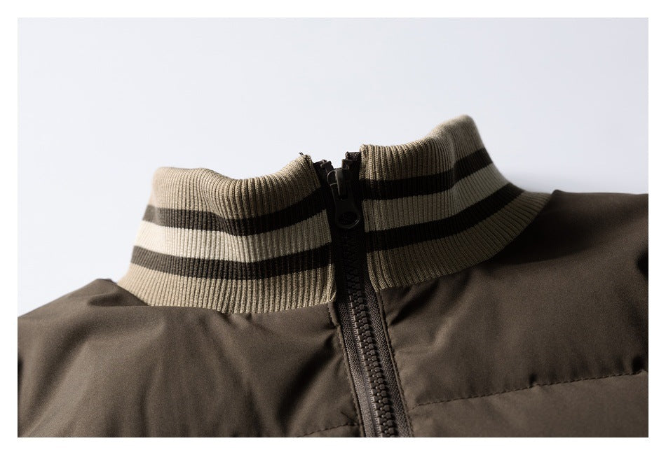 Close-up of a dark brown jacket collar with beige and black striped ribbing and a central zipper.