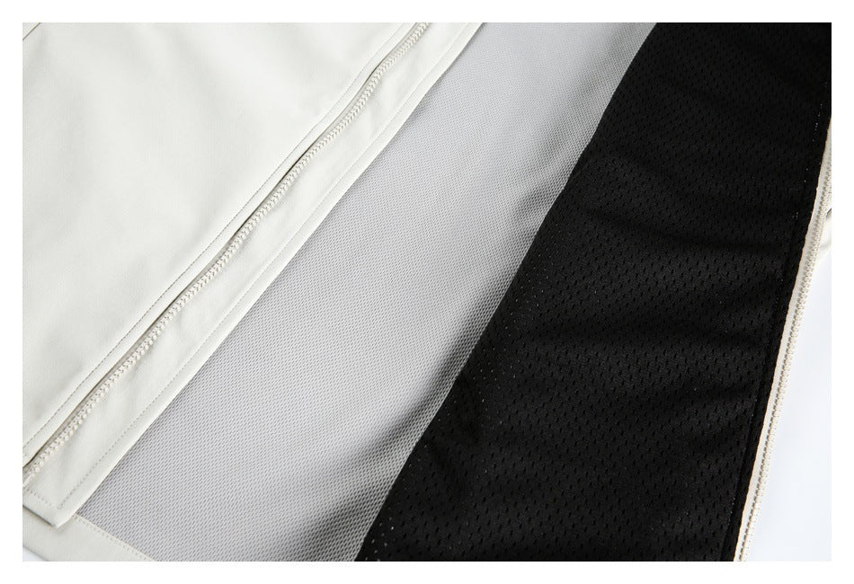 Close-up of the ivory garment opened to show gray and black mesh lining beside a zipper.