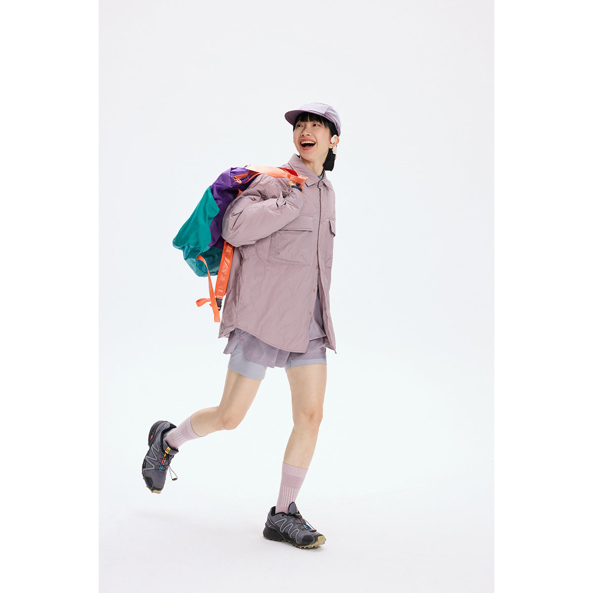 A model wears a dusty mauve oversized button-front shirt with chest flap pockets and matching shorts.