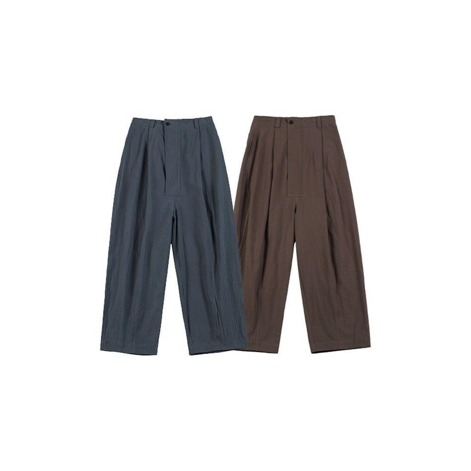 Two pairs of wide-leg pleated trousers shown from the front in slate blue and brown.