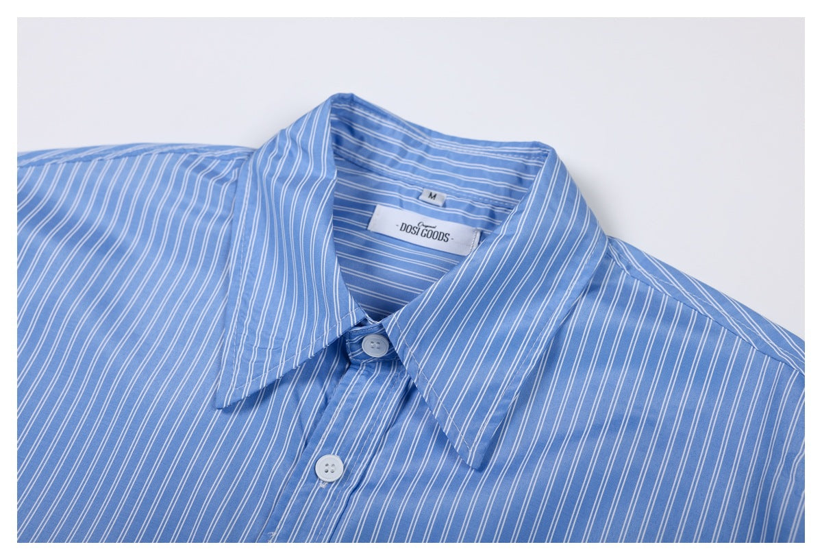 Close-up of the blue-and-white striped shirt's pointed collar and upper button placket.