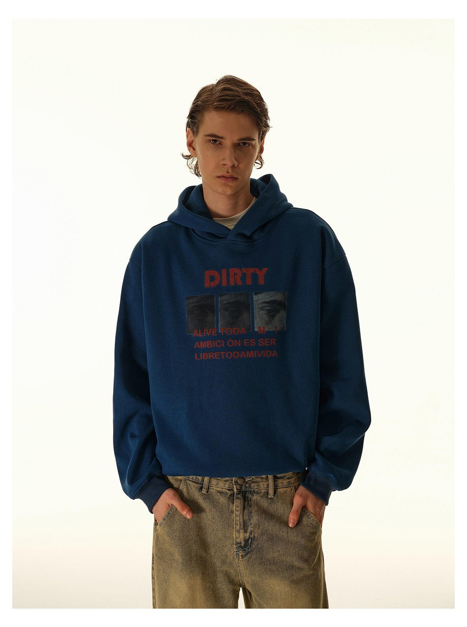Model wearing a navy graphic hoodie and loose tan jeans, framed from the thighs up.