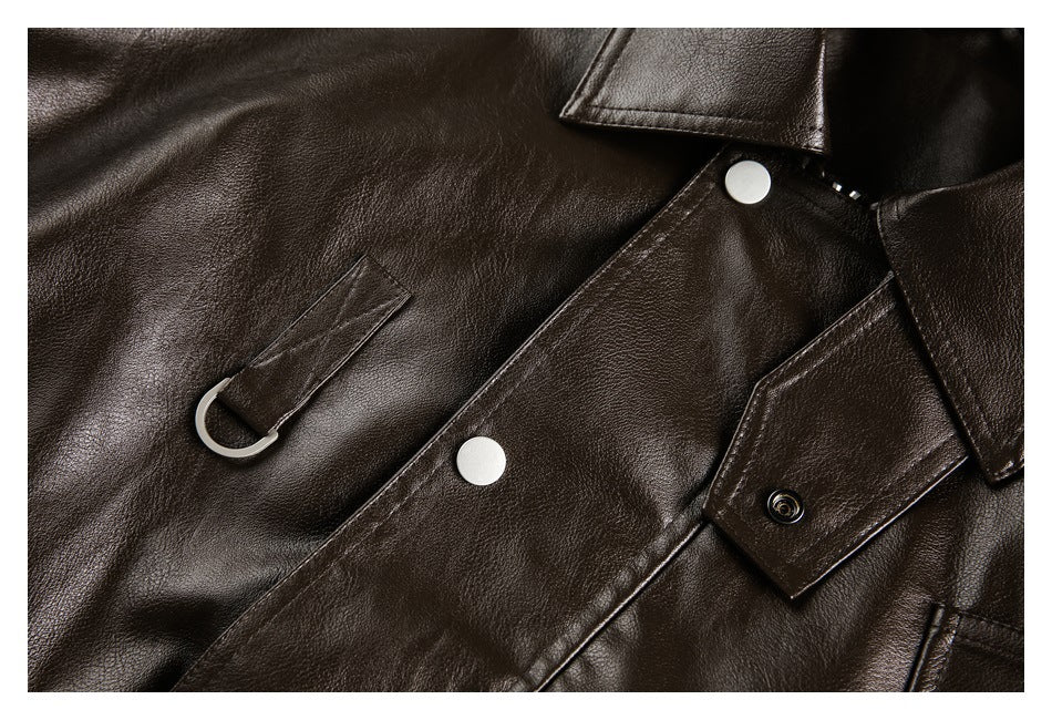 Close-up of a dark brown jacket front showing a metal ring detail and snap-button placket.