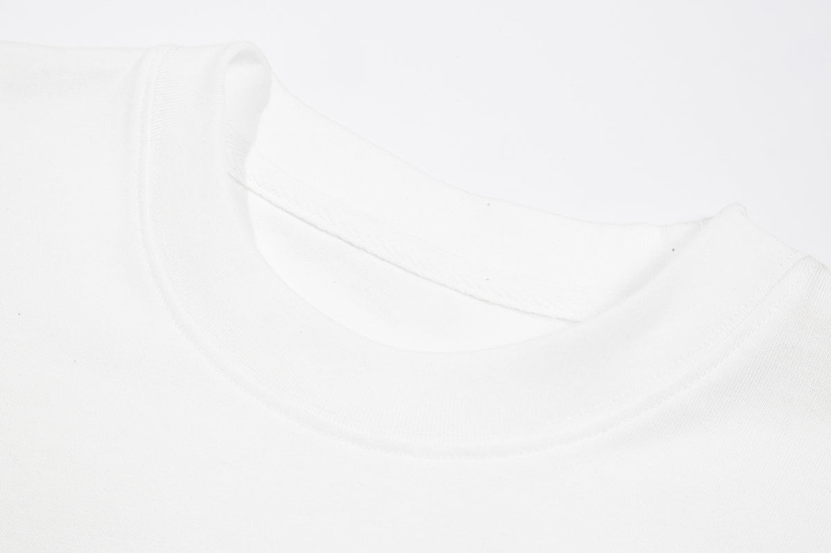 Close-up of the white T-shirt's ribbed crew neckline and seam.