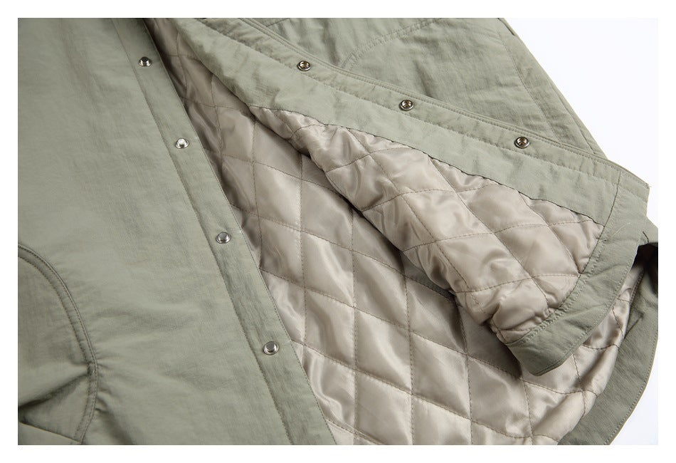 Open gray-green jacket showing its diamond-quilted beige lining and metal snap closure.