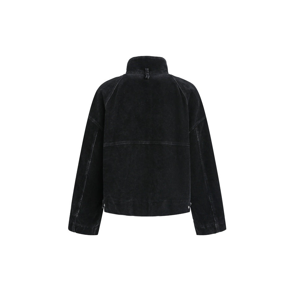 Back view of a black cropped jacket with a raised collar, raglan sleeves and a horizontal seam across the back.
