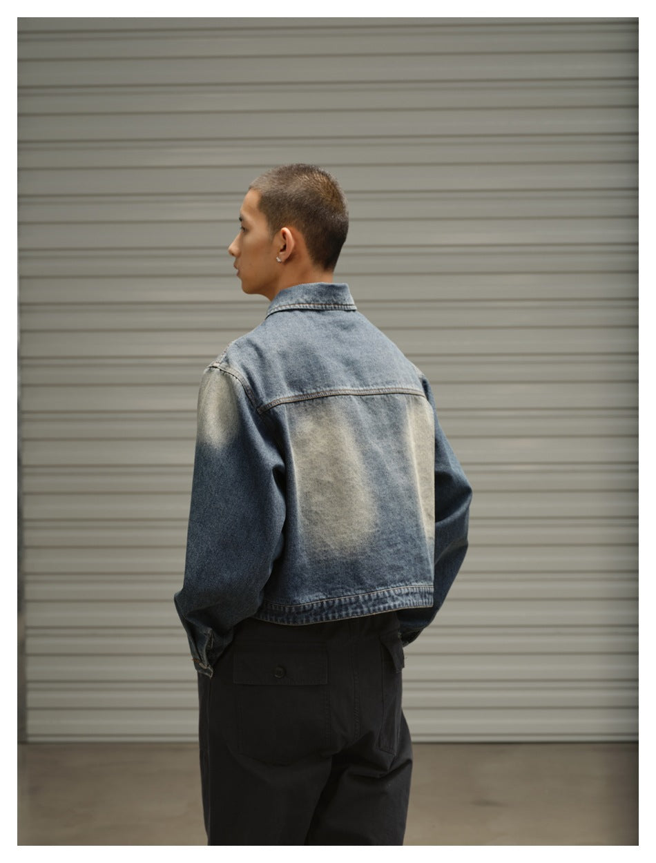 Model shown from behind wearing a faded blue denim jacket with a light washed panel across the back.