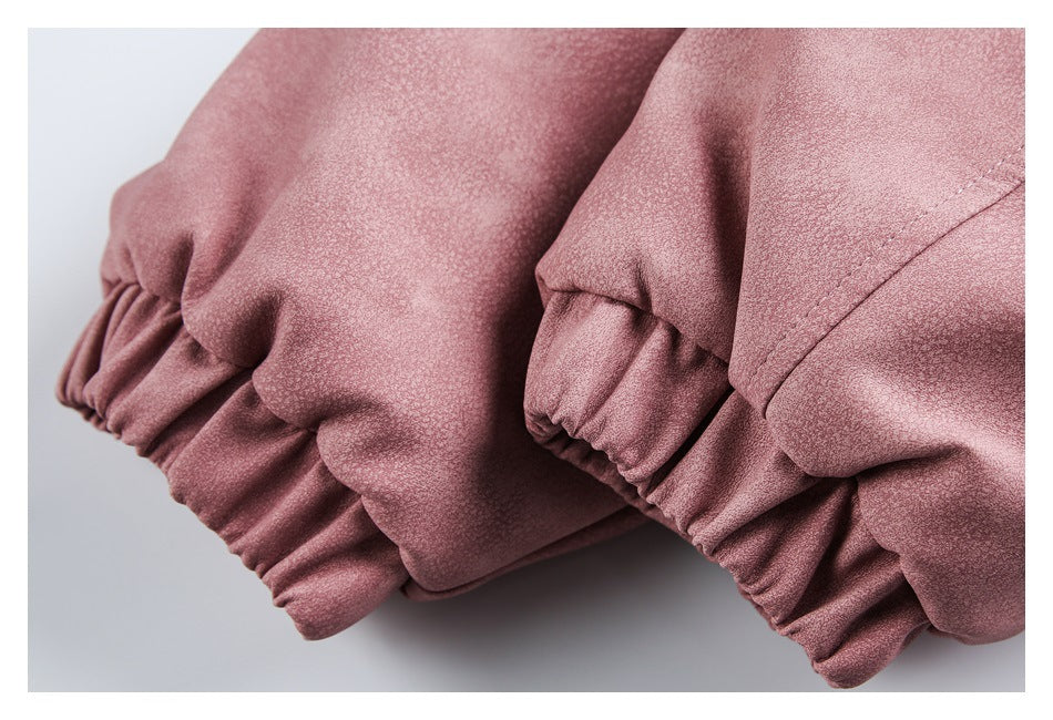 Close-up of gathered elastic cuffs on dusty rose jacket sleeves.