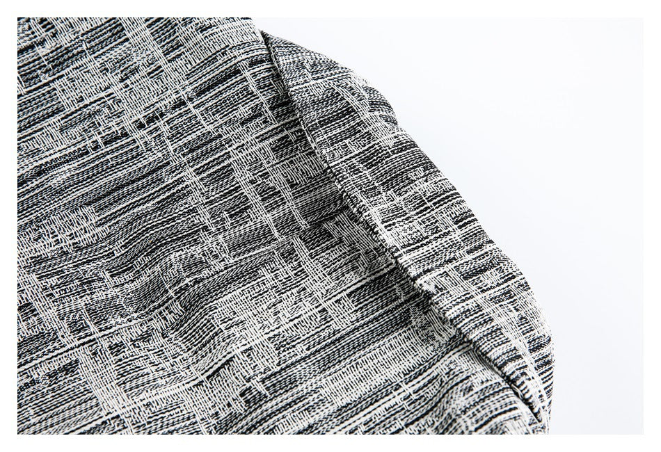 Close-up of patterned black-and-white garment fabric folded along a curved edge.
