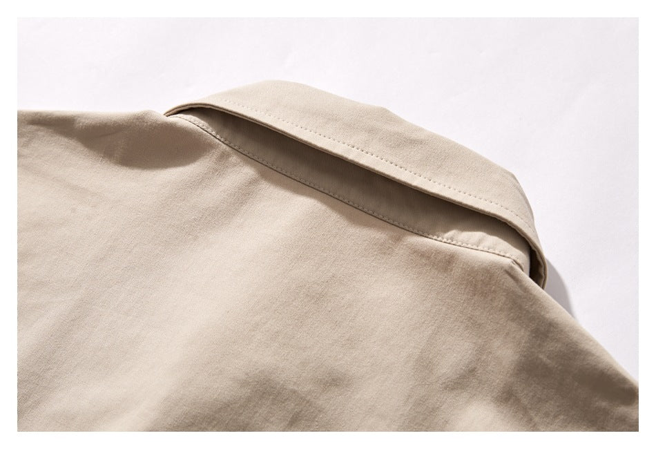 Close-up of the beige shirt's collar and upper back.