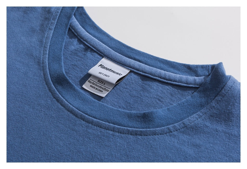 Close-up of a blue T-shirt's crew neckline and interior label.