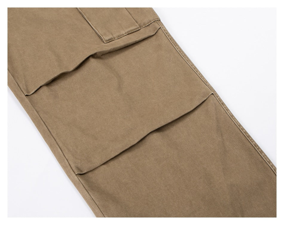 Close-up of tan trousers showing a large flap cargo pocket.