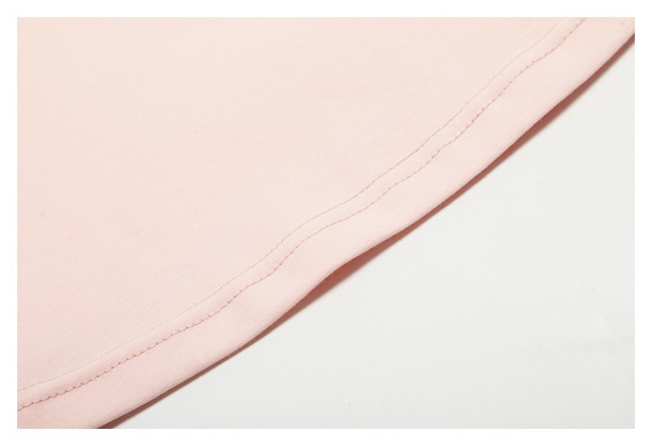 Close-up of a pale pink garment hem with parallel rows of stitching.