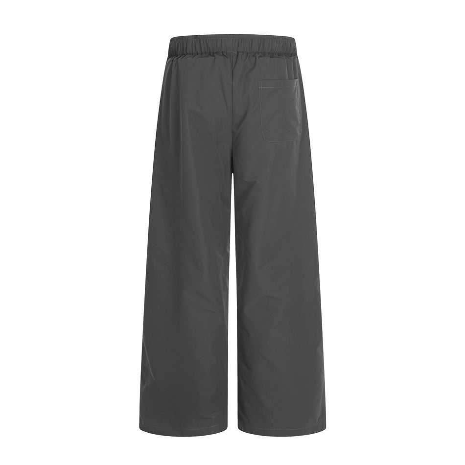 Back view of charcoal wide-leg pants with an elastic waistband and a single patch pocket.