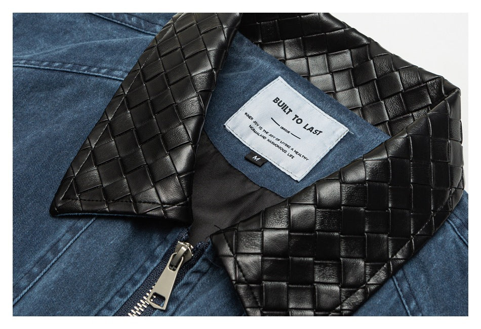Close-up of a blue denim jacket's black woven-texture collar, zipper, and sewn-in white label.