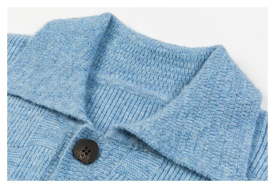 Close-up of a light blue knit cardigan collar, ribbed trim, and dark button.