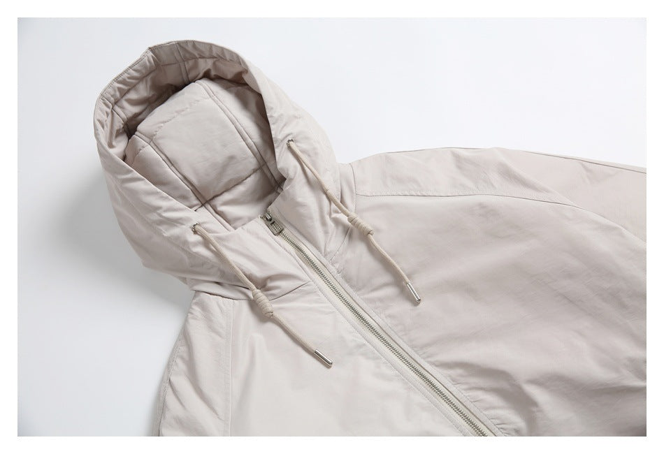 Angled close view of the light beige jacket's hood, drawcords, and front zipper.