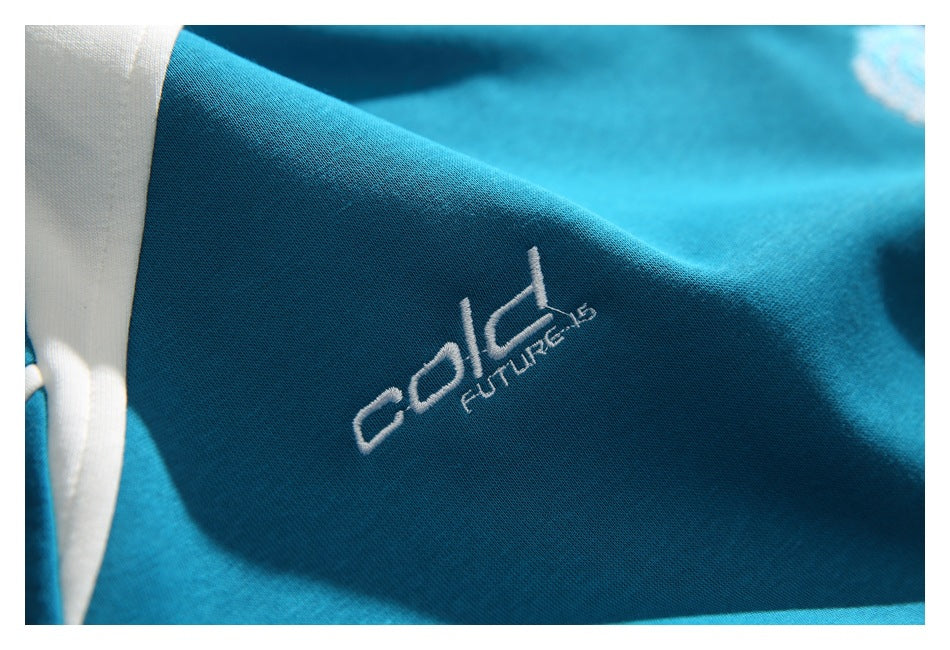 Close-up of a teal garment with a white embroidered logo on the fabric.