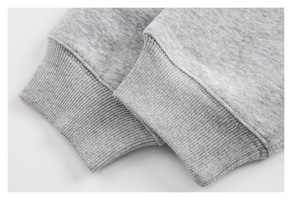 Close-up of ribbed cuffs on a heather-gray sweatshirt.