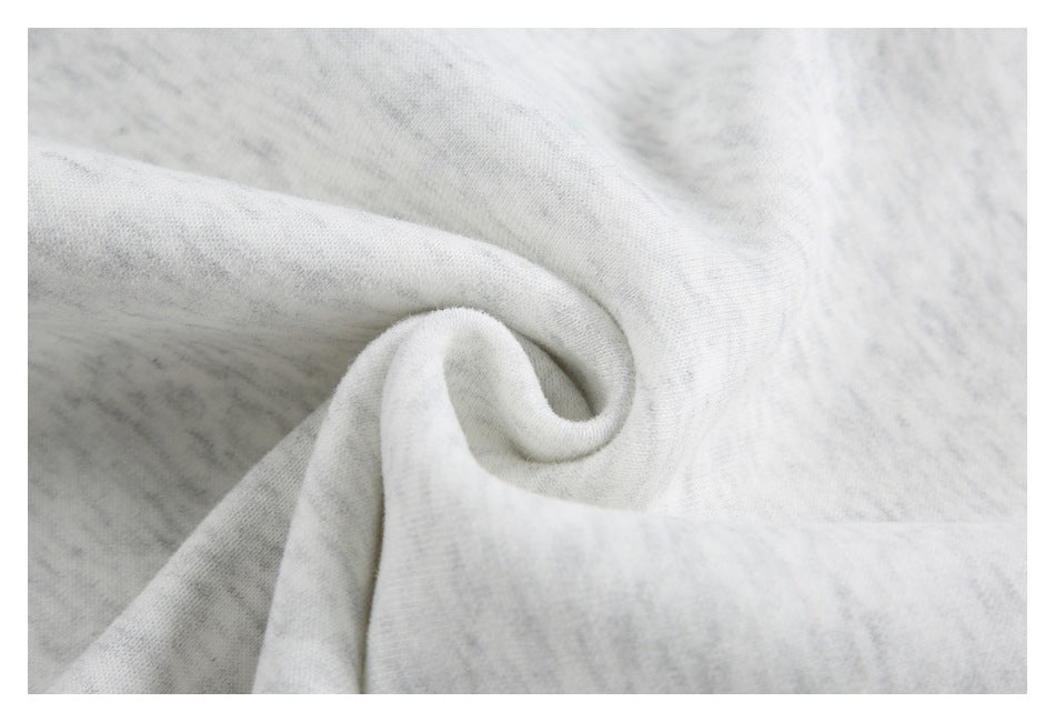 Close-up of light heather gray fabric gathered into a soft fold.