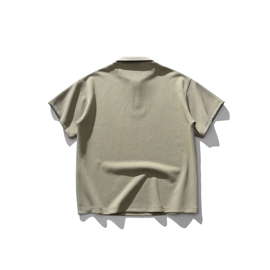 Back view of a khaki short-sleeve collared shirt laid flat against a white background.