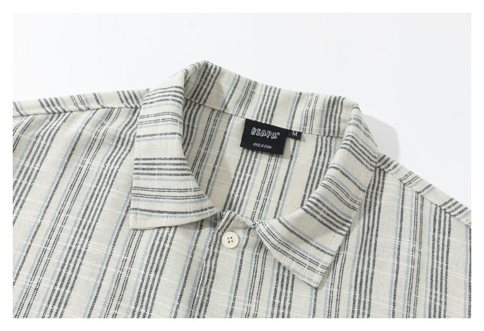 Close-up of the ivory shirt's striped collar, top button, and neck label.