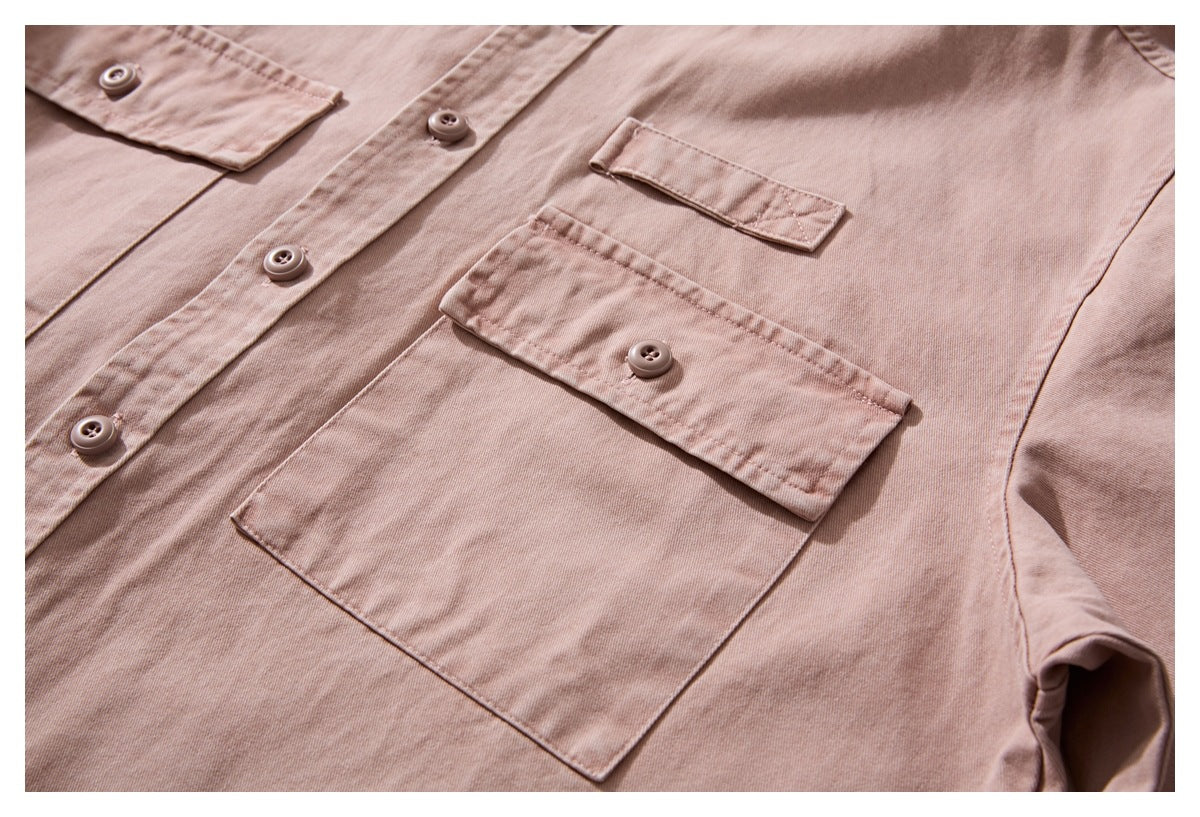 Close-up of the dusty rose shirt front, showing buttoned flap chest pockets and the button placket.