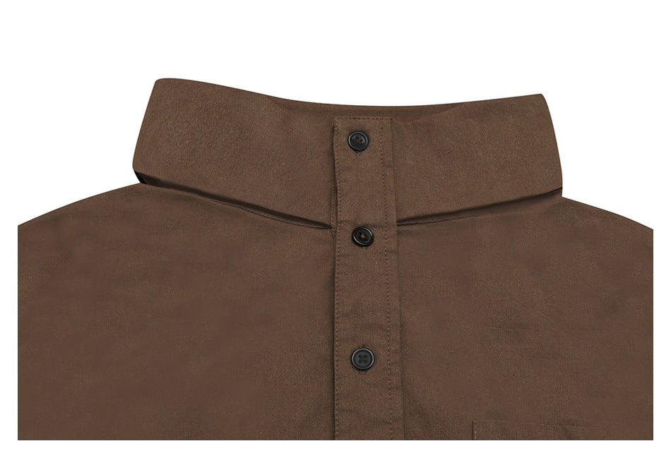 Close-up of a brown shirt’s stand collar and black-button placket.
