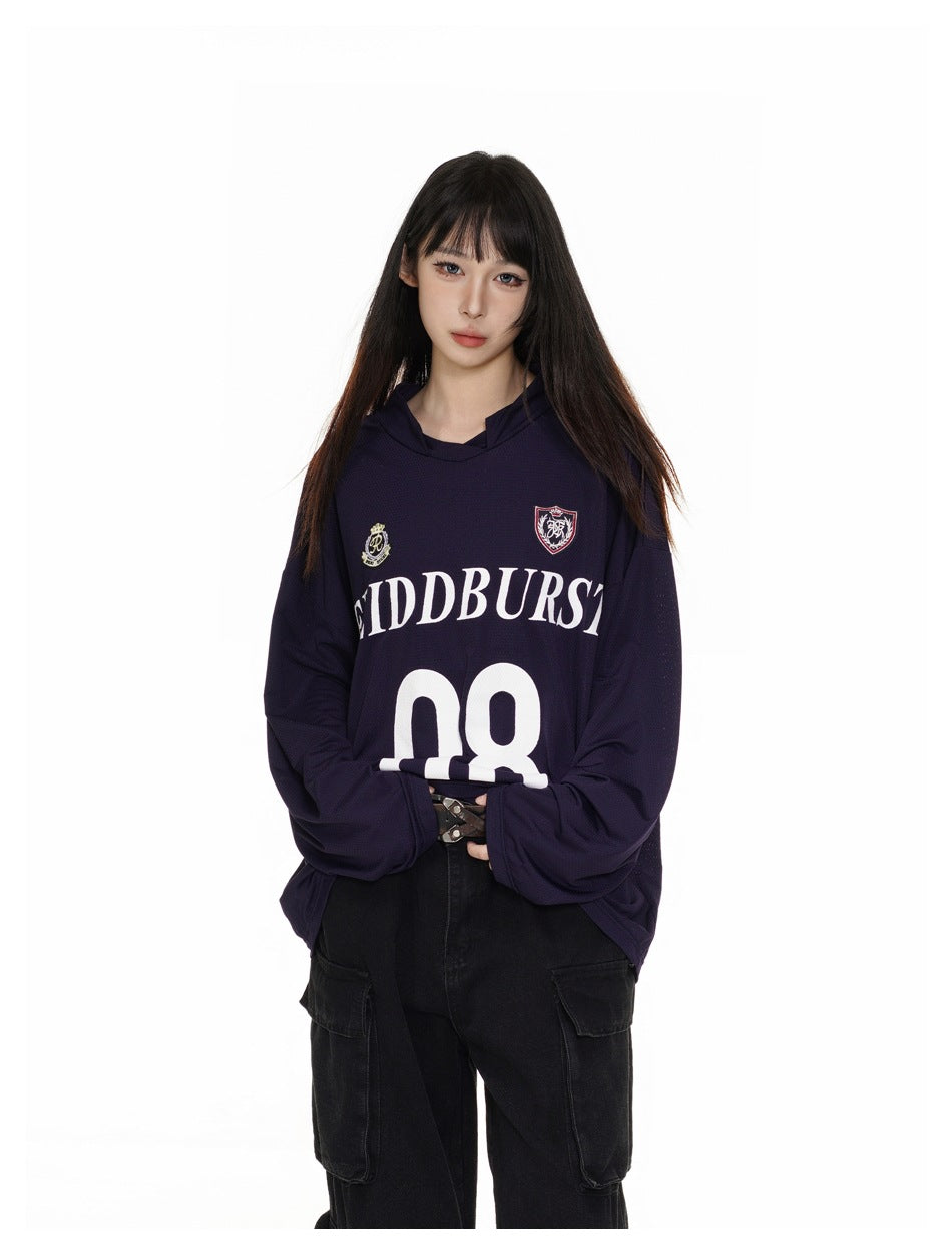 Closer view of a model wearing a dark navy hooded jersey with crest graphics and a large white 08.