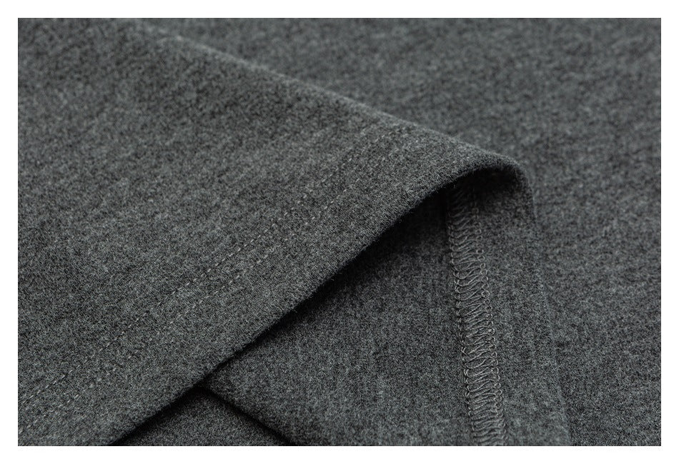 Close-up of dark gray fabric folded to show a narrow overlocked seam.