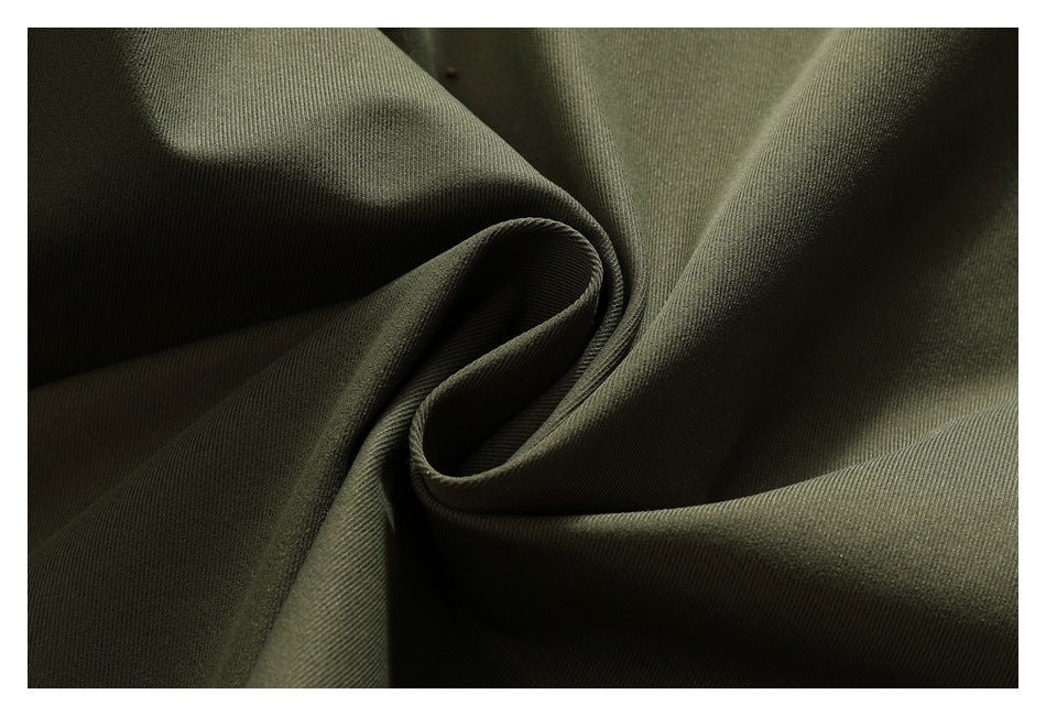Extreme close-up of olive-green fabric draped into soft folds.