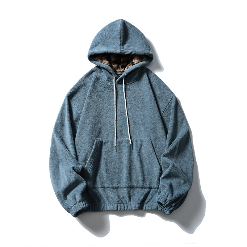 Misty blue fleece-like pullover hoodie with kangaroo pocket, white drawcords and patterned plush hood lining, flat lay