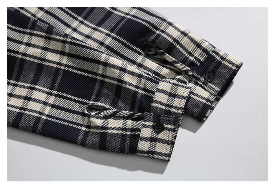 Close-up of the plaid shirt cuff with a button and adjustable button tab.