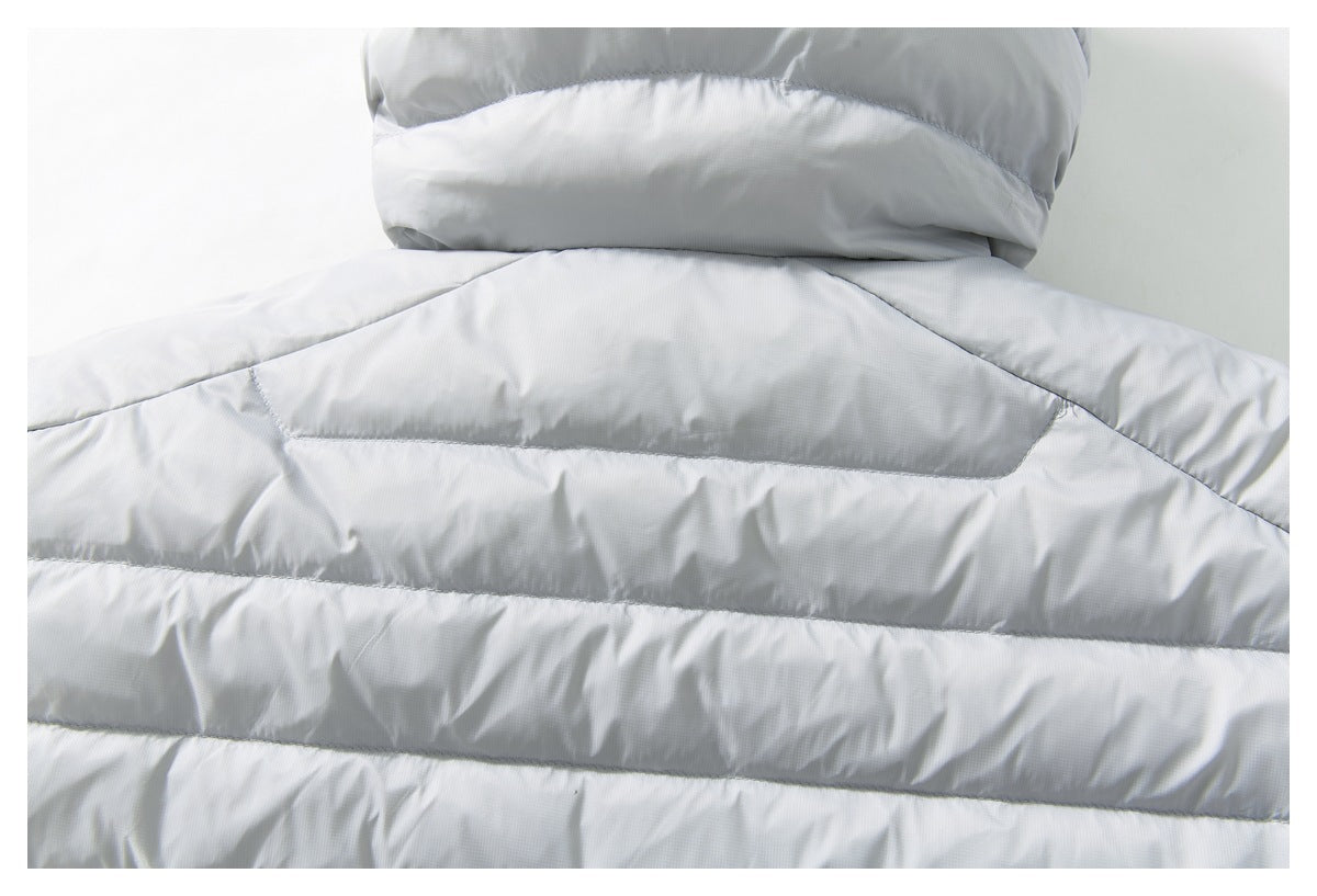 Close-up of the light gray jacket's upper back, showing the hood seam and horizontal quilted panels.