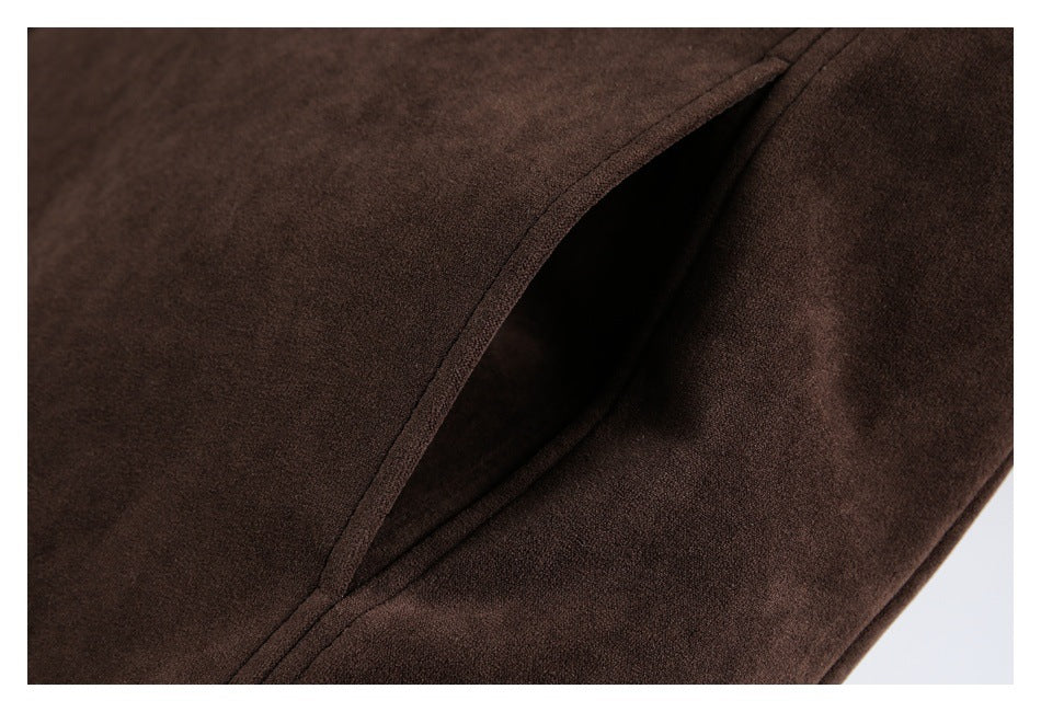 Close-up of a slanted pocket opening on the dark brown coat.