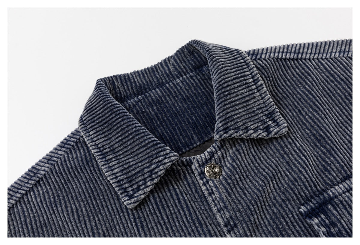 Close-up of the jacket's ribbed collar, shoulder seam, and ornate front button.