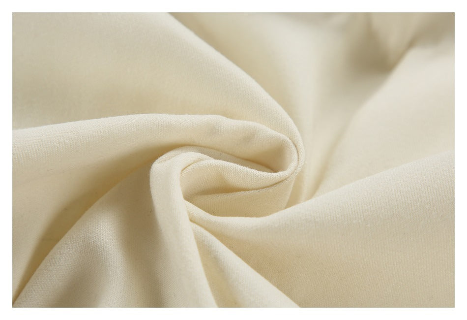 Close-up of cream fabric softly twisted to show its drape and surface texture.