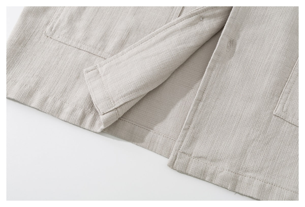 Close-up of the light beige shirt's lower hem and side slit.