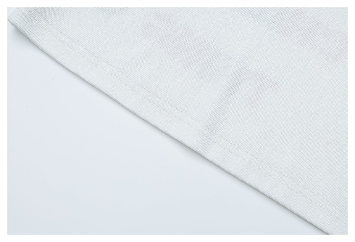 Close-up of a diagonal stitched hem on white fabric.