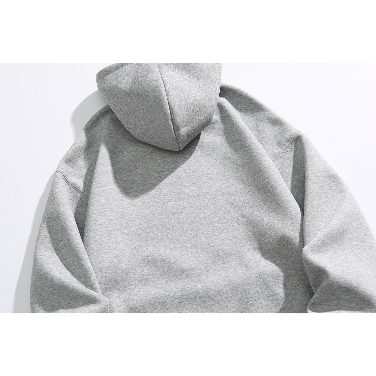 Back view of a heather gray pullover hoodie with a plain body and attached hood.