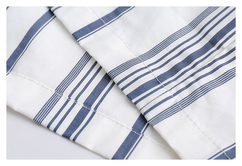 Close-up of intersecting navy stripes and seams on the white shirt.