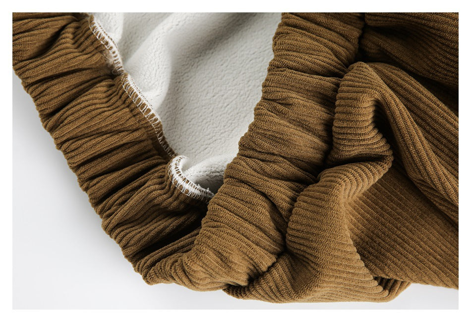 Close-up of the jacket's white fleece-like interior lining and camel-brown ribbed fabric at the seam.
