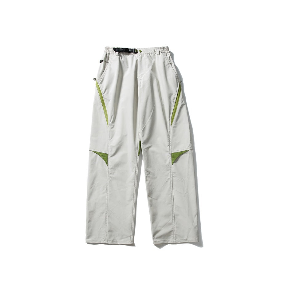 Light gray wide-leg pants with green zipper and knee panel accents, belt buckle and elastic waist, laid flat