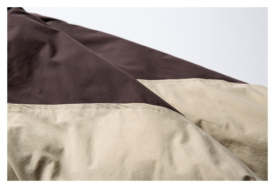 Close-up of the jacket's dark brown and beige color-blocked panels.